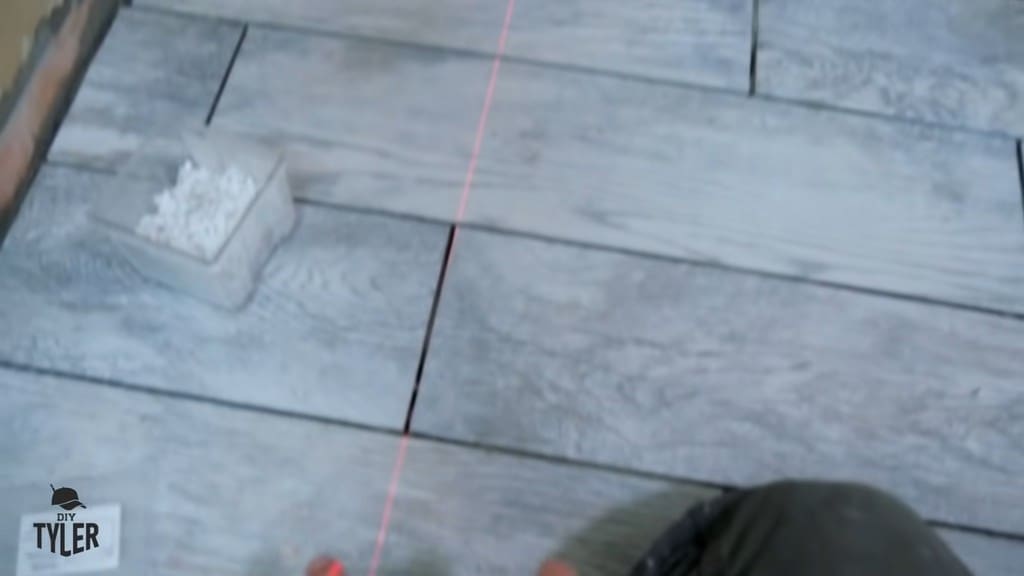 laser level used for reference point for DIY tiling in bathroom