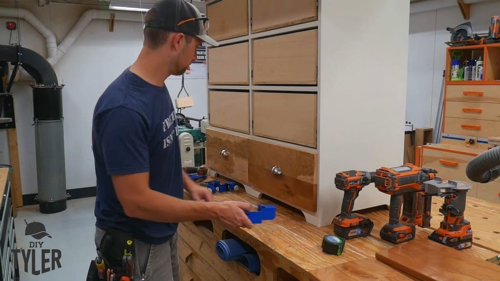 man standing in front of completed drawer fronts