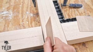 man inserting shim into half-lap joint