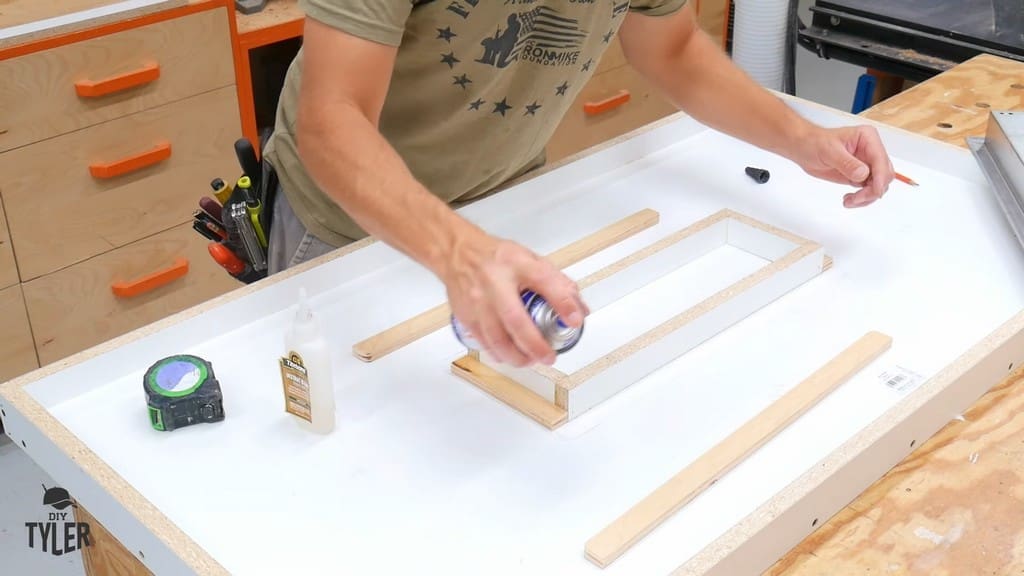 man spraying area around negative impression form for concrete mold