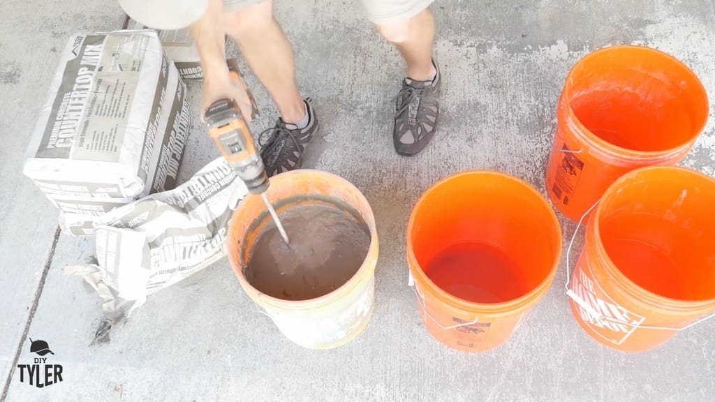 man mixing bucket of DIY concrete mix