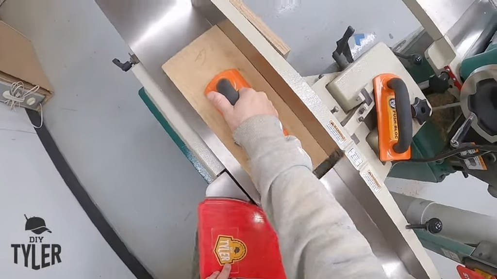 man running spalted maple board through jointer