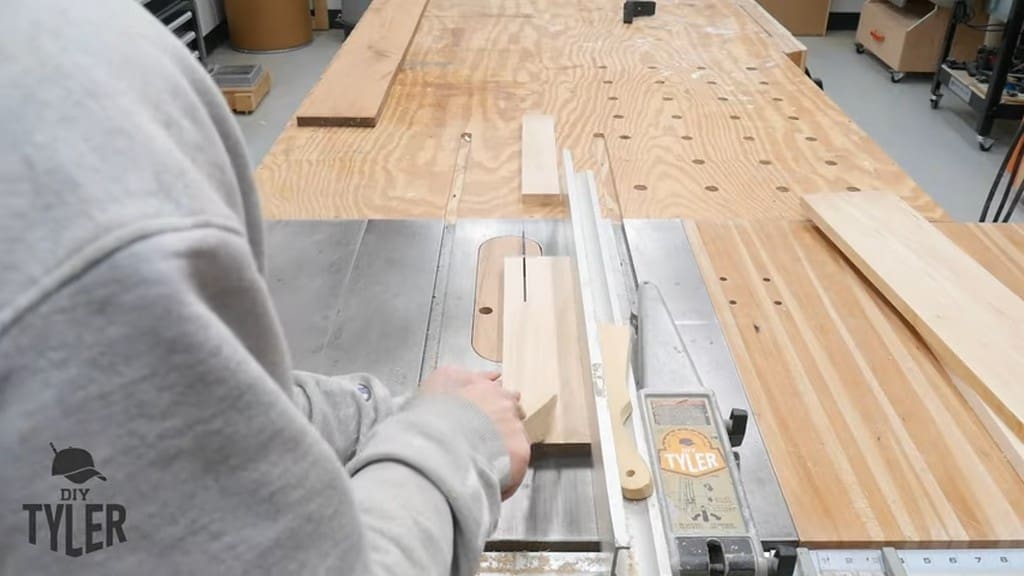 man running spalted maple board through table saw