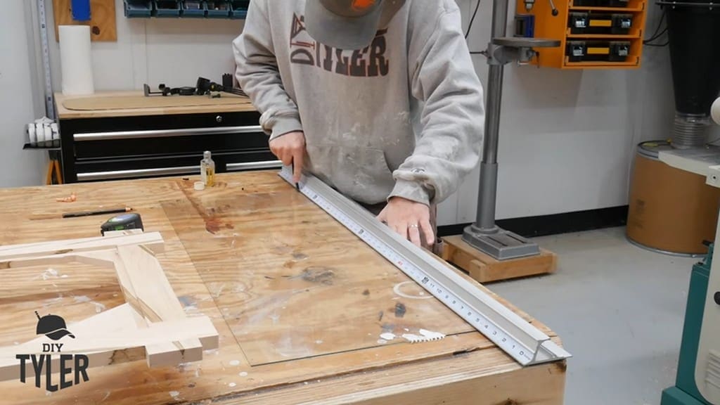 man measuring sheet of glass