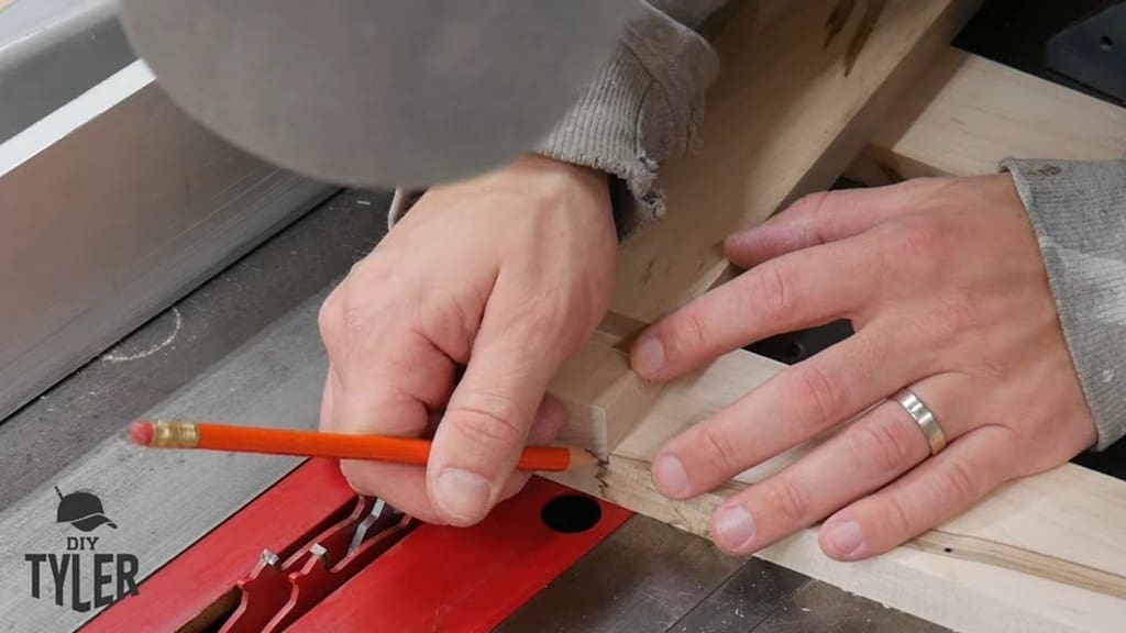 man marking spacing on maple wood board