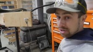 man gesturing to steam box in shop