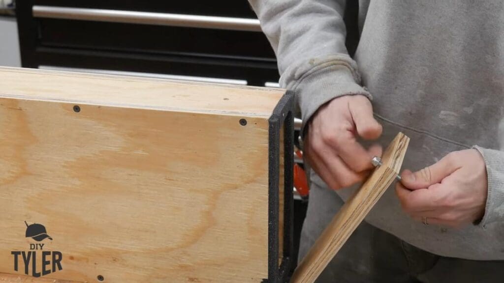 man tightening bolt for door to steam box