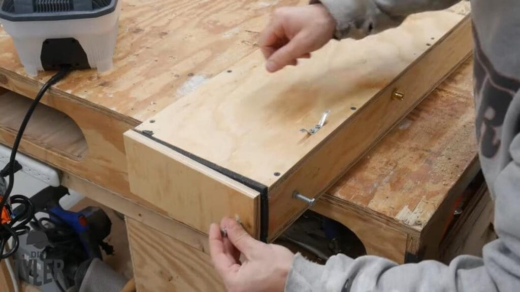 man tying paracord around bolts on steam box