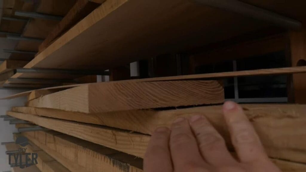 man gesturing to pieces of ash wood board