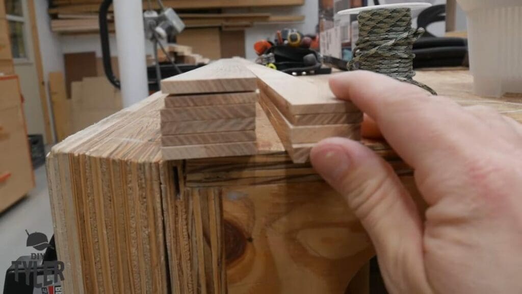 man gesturing to pieces of ash wood board