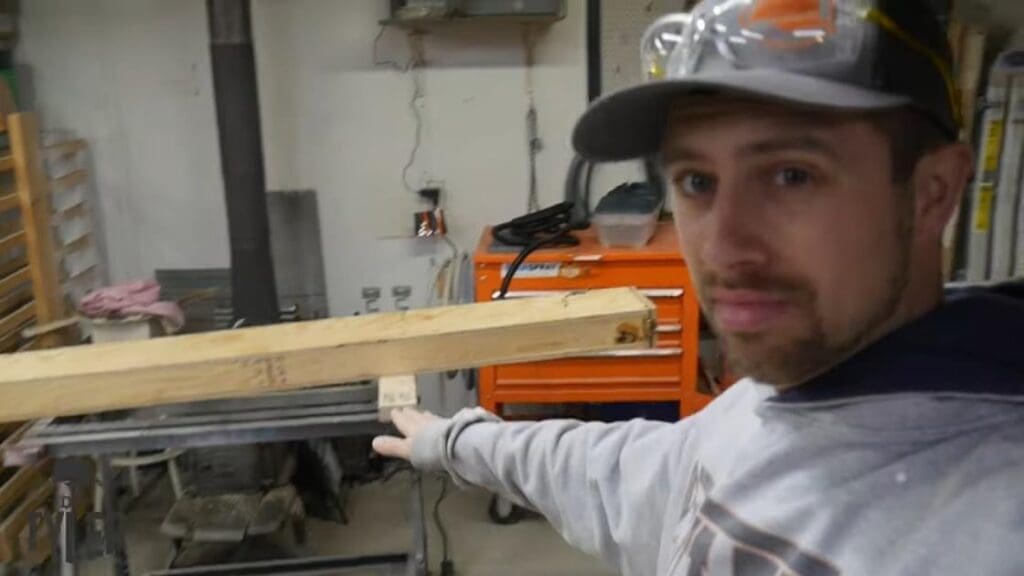 man gesturing to steam box set at incline in workshop