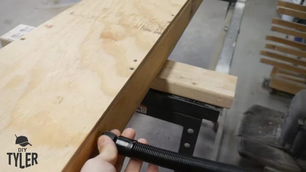 man affixing steam hose to steam box