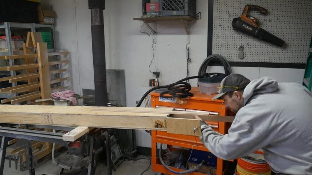 man inserting ash wood into steam box