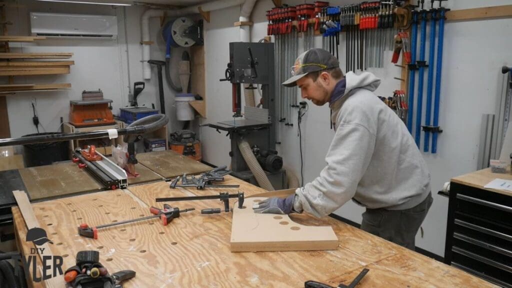 man bending steam-treaded wood onto mold